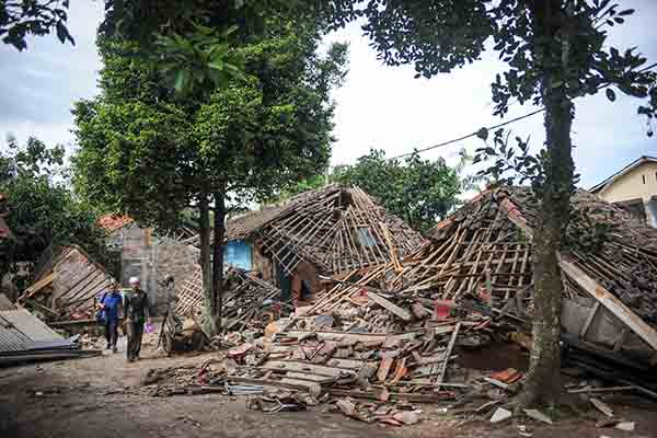 Warga melintas di depan rumah yang roboh akibat gempa di Kampung Selakawung Tengah, Kabupaten Cianjur, Jawa Barat, Selasa (22/11/2022).